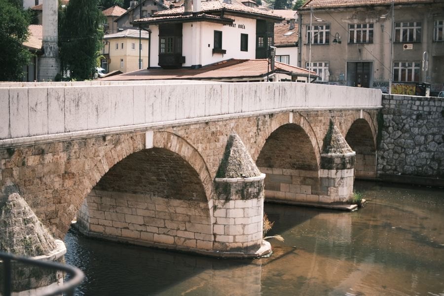 An old stone bridge arching across a river